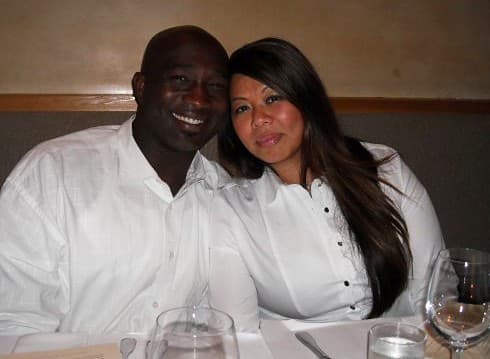 Two people smiling at restaurant table