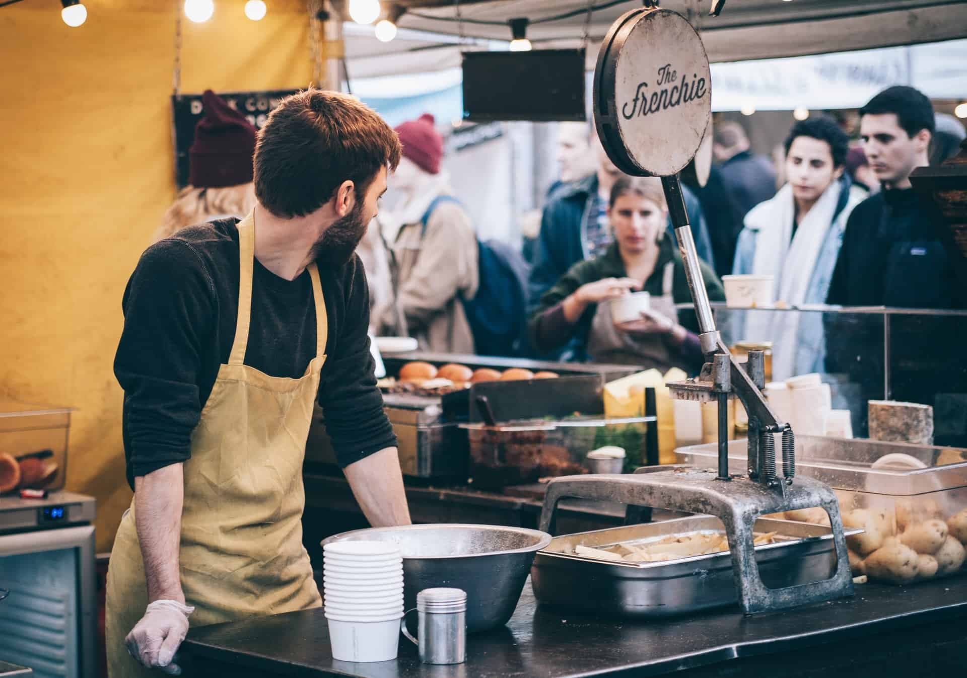 Food vendor at The Frenchie stand serving customers