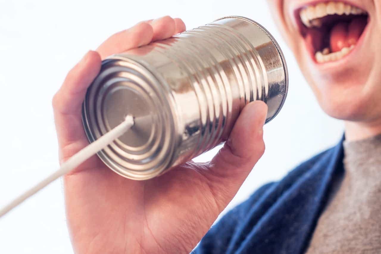 Child using tin-can telephone made with string