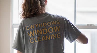 Person wearing window cleaning company branded gray shirt