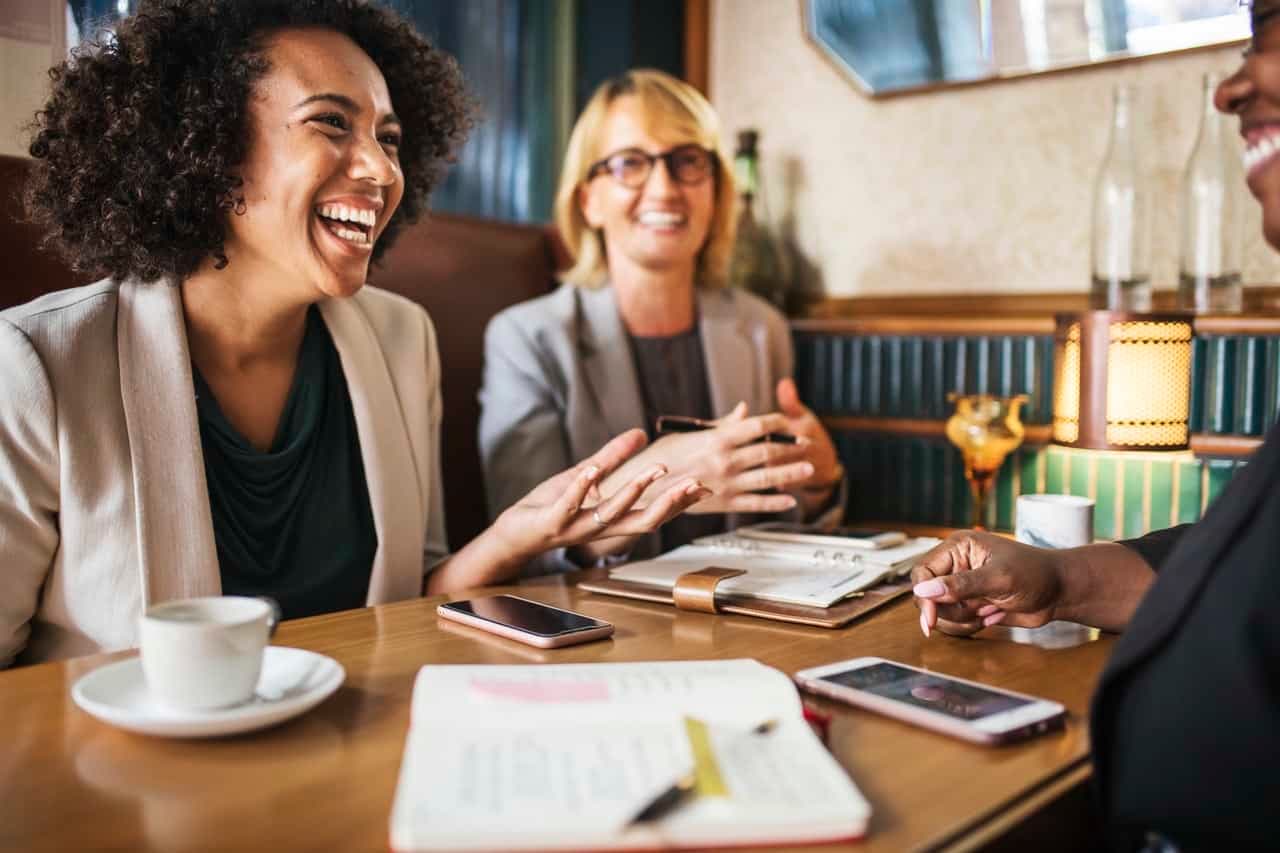 Women in business meeting discussing strategy at table