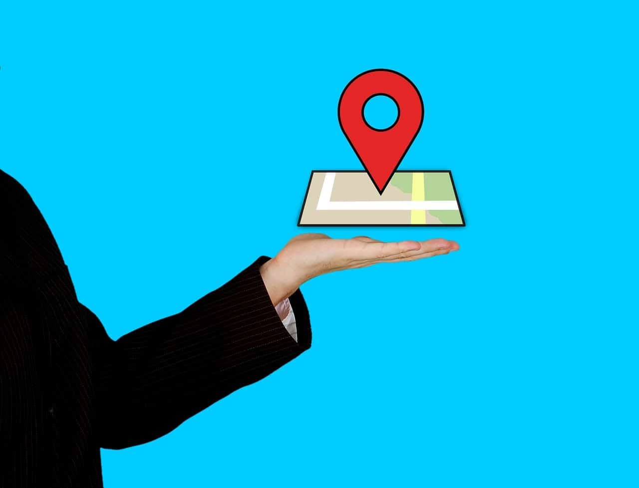 Illustration of hand holding map with red location pin marker