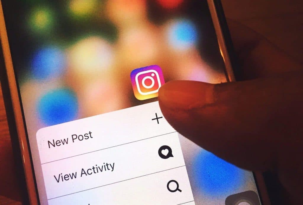 Instagram menu showing New Post and View Activity options on phone