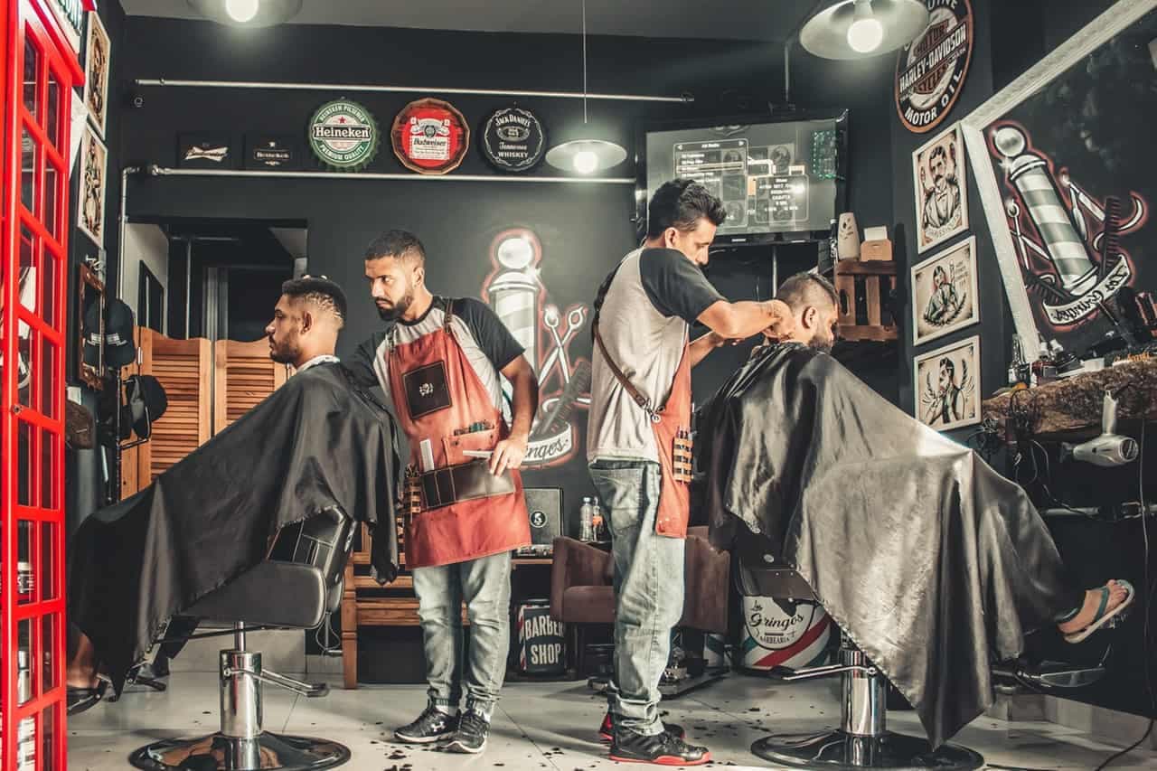 Barber shop with barbers providing haircut services to customers