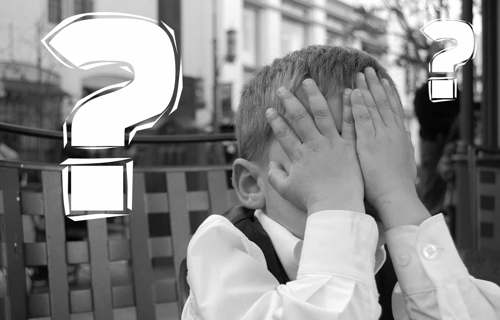 Young person with hand on head and question mark graphics showing confusion