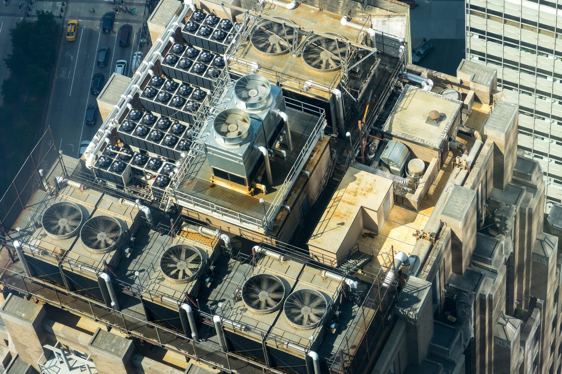 Aerial view of building rooftop with HVAC cooling units and equipment