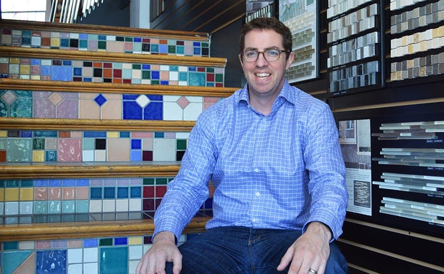 Man smiling in tile and flooring showroom