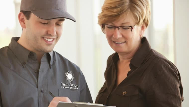 Service technician and customer reviewing information on tablet together