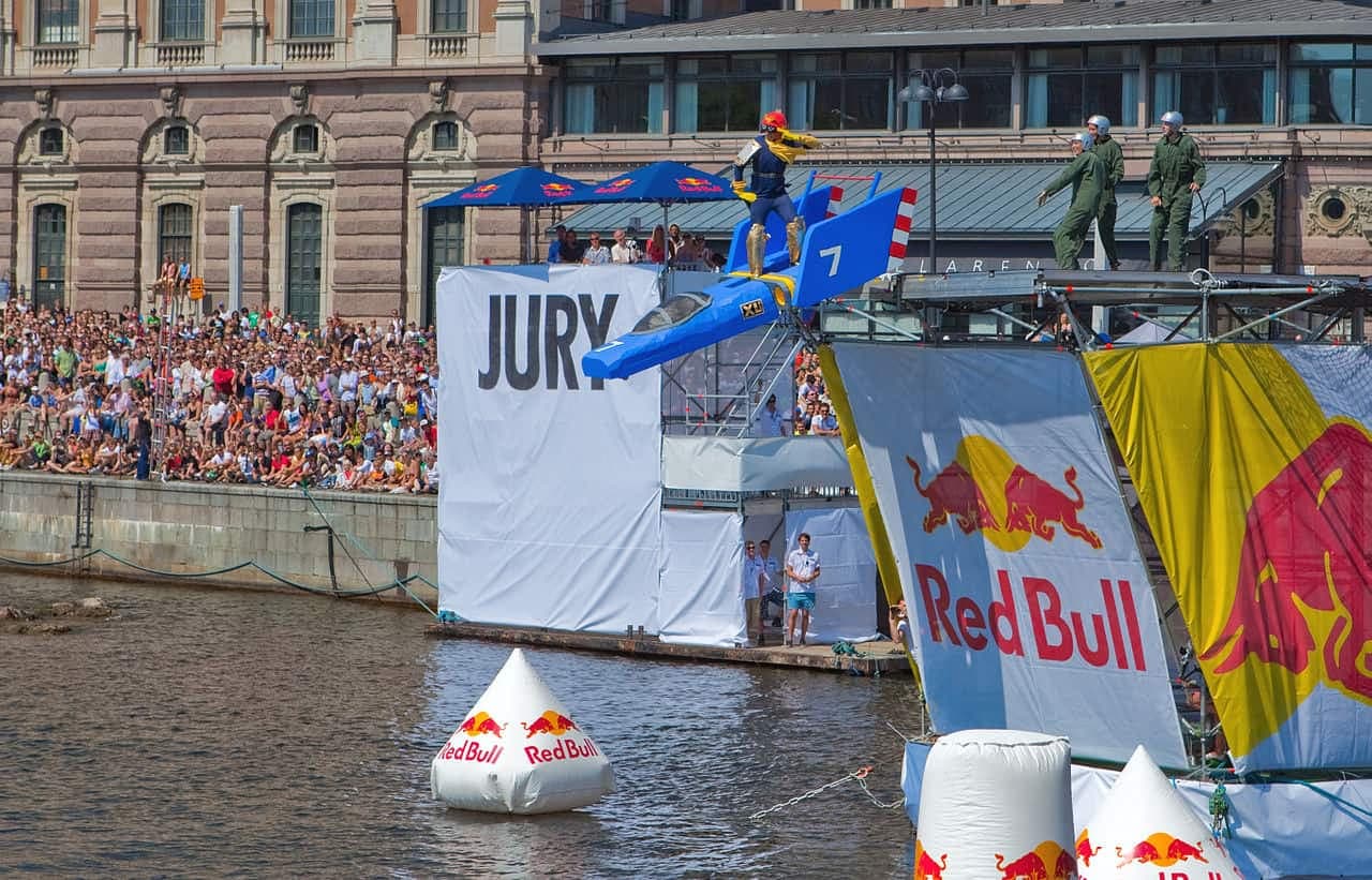 Red Bull sponsored stunt plane event with large crowd and jury