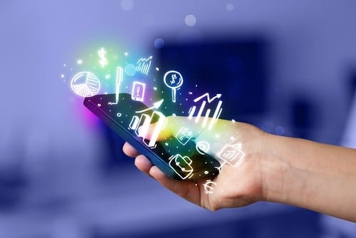 Hand holding smartphone displaying colorful analytics and business icons