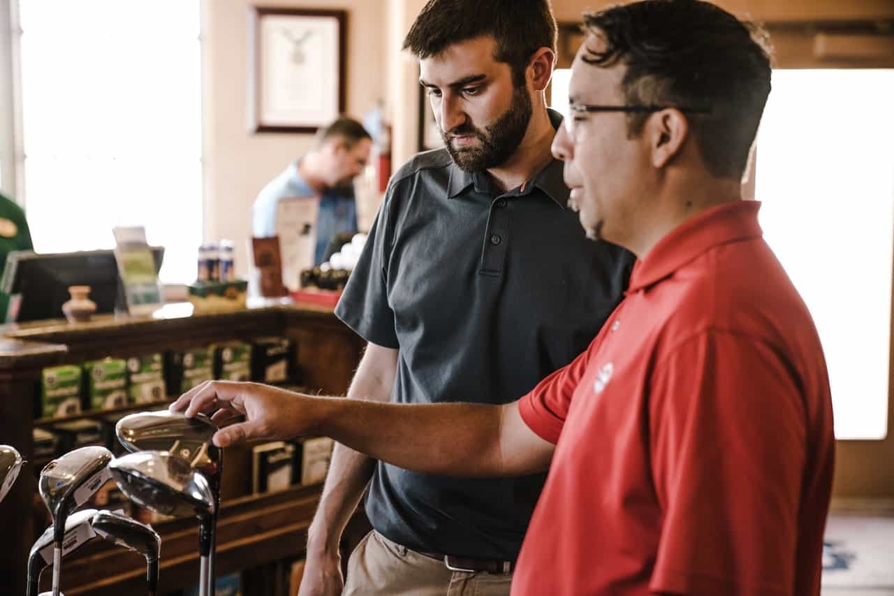 Customer and employee discussing product at retail counter