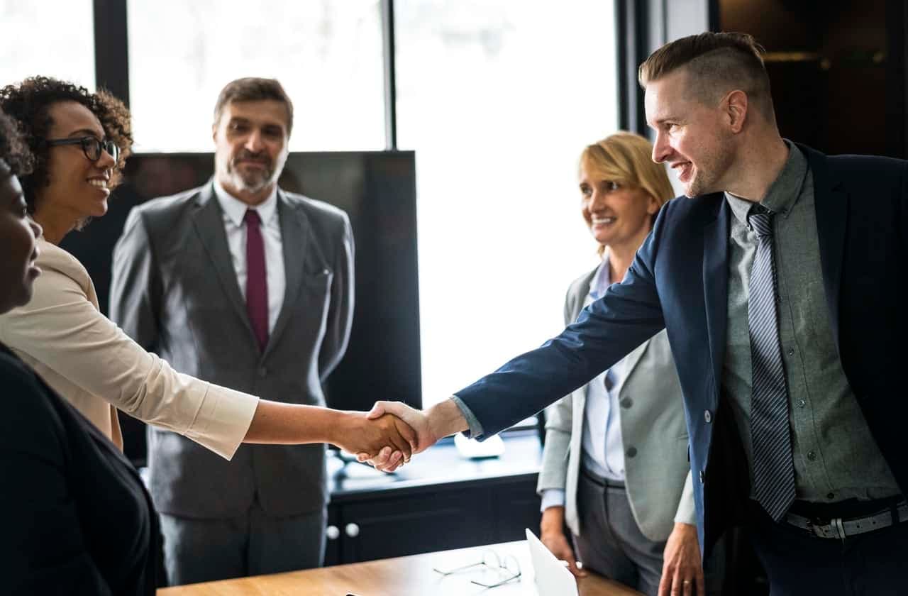 Business professionals shaking hands in meeting