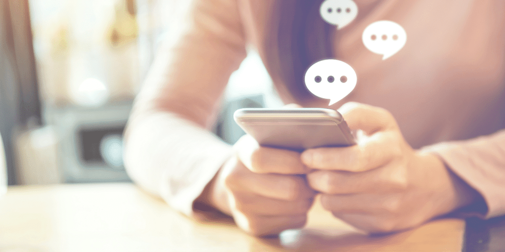 Person holding smartphone with message bubbles showing customer communications